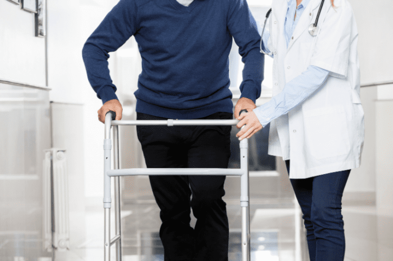 2022-03-08-12_03_01-Midsection-of-Doctor-Assisting-Senior-Man-with-Walker-Photos-by-Canva-768x510